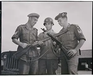 Soldiers Comparing Their Weapons
