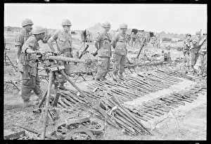 Soldiers Examining Captured Weapons