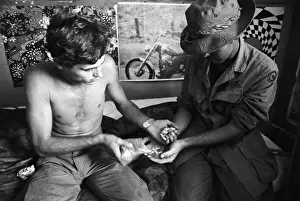 Vial Prints: Two Soldiers Exchange Vials of Heroin
