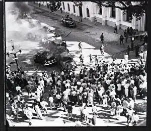 Burned Prints: Soldiers Guard Cars Burned in Street