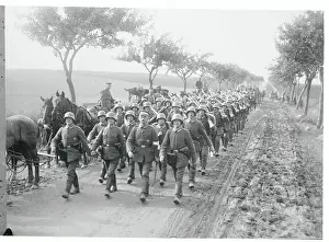 Soldiers Marching in Formation Along Road