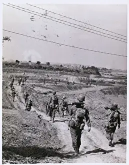 Soldiers Patrolling Dirt Road