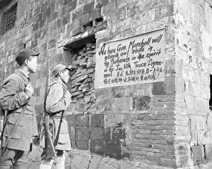 Soldiers Reading Sign