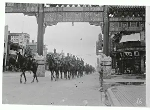 Soldiers Riding Horseback Through City