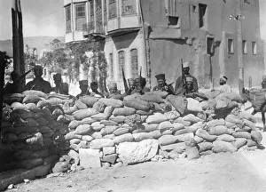 Soldiers Standing Behind Street Barricade