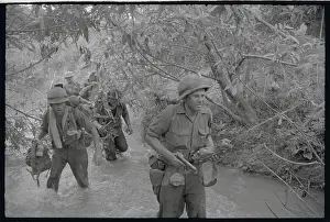 Soldiers Wading Through River in North Vietnam