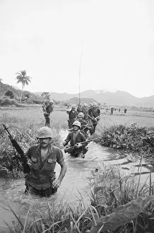 Soldiers Wading Through Water In Vietnam