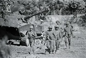 Wreck Prints: Soldiers Walk Past Destroyed Tank