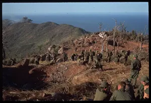 US Soldiers Walking in Line Along Hill