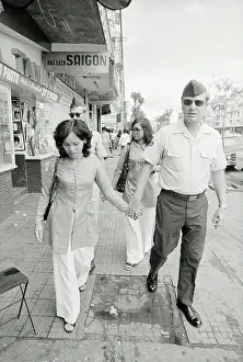 Two Soldiers Walking with Vietnamese Women