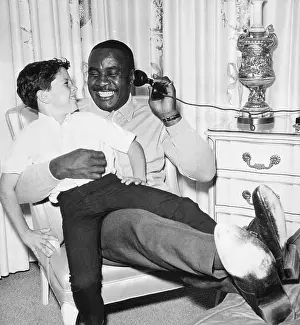 Sonny Liston On Phone W/Child On Lap