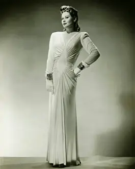 Glove Prints: Sophisticated woman in evening gown posing in studio, (B&W), portrait
