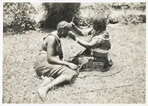 South African Woman Grooming Another's Hair with Elaborate Braids