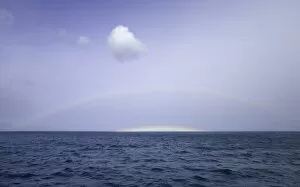 South Georgia, rainbow and cumulus clouds over calm sea, autumn