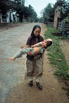 South Vietnamese Woman Carrying Her Wounded Son