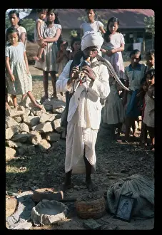 Eerie Prints: Spectators at Snake Charming Event