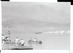 Spectators Watching a Passing Speedboat