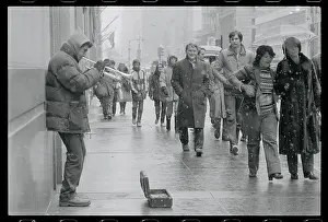 Spectators Watching a Trumpet Player