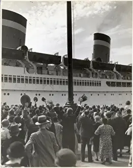 Spectators Wave to Passengers on Ship