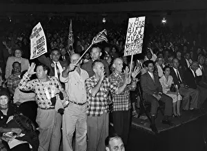 Spectators Wave Signs Protesting Integration