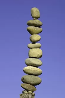 South Island New Zealand Gallery: Stack of stones on fence post, low angle view