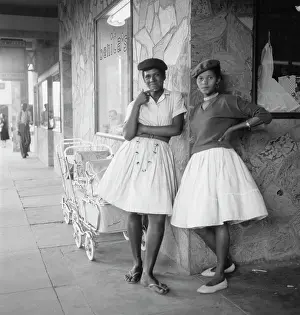Prints of Two young women outside a store called Benita's, with two prams parked outside the store, in Windhoek, Namibia, circa 1965. (Photo by Rudi Herzog/Archive Photos/Getty Images) Timeless Moments: A Visual Journey Through History’s Defining Images: Standing On A Street Corner Waiting For No One Is Power