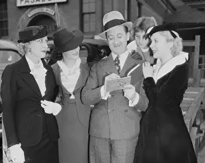 Fedora Prints: Stanley Lupino Signing an Autograph Beside His Family