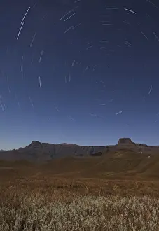Star trails over the Amphitheatre range in the Drakensberg mountains, Kwazulu-Natal, South Africa