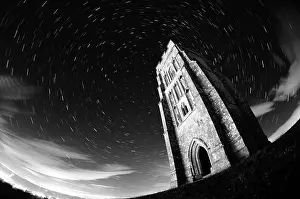Prints of Star trails through the sky caused by the earth's constant rotation and captured using long exposure techniques. The trails are centred on Polaris. The structure is St Michael's Tower, Glastonbury A Captivating Visual Journey Through Somerset's Nature and History: Star Trails around St Michael's Tower, Glastonbury