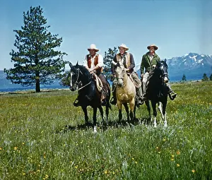Grassland Prints: Stars of Bonanza Sitting on Horses in Open Field