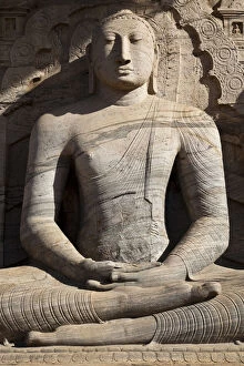 Human Representation Gallery: Statue of a sitting Buddha attached to the rock
