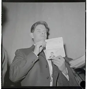Staughton Lynd Holding up Passport for Press