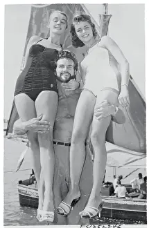 Steve Reeves Posing with Beauty Contestant Winners on Shore