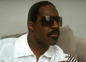 Prints of Musician Stevie Wonder poses for a portrait session on a couch wearing a white track suit at home in 1984. (Photo by Michael Ochs Archives/Getty Images) Visions of Wonder: Iconic Moments Captured: Stevie Wonder Portrait Session At Home
