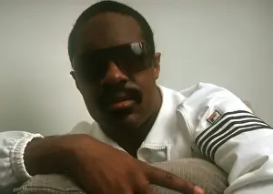 Prints of Musician Stevie Wonder poses for a portrait session on a couch wearing a white track suit at home in 1984. (Photo by Michael Ochs Archives/Getty Images) Visions of Wonder: Iconic Moments Captured: Stevie Wonder Portrait Session At Home