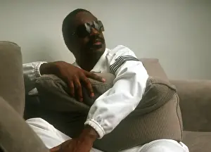 Prints of Musician Stevie Wonder poses for a portrait session on a couch wearing a white track suit at home in 1984. (Photo by Michael Ochs Archives/Getty Images) Visions of Wonder: Iconic Moments Captured: Stevie Wonder Portrait Session At Home