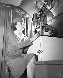 Displaying Prints: Stewardess Showing Talking Movie on Flight
