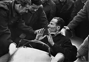 Prints of British Racing driver Stirling Moss is questioned by the Mercedes Benz team experts after his trial run in one of the cars. The man on the left is Uhlenhalt, chief of research and development Vintage Car Collection Prints: Stirling Moss