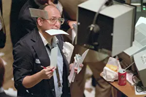 Stock Exchange Worker Draped in Orders