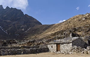 Stone house in dusty mountain valley