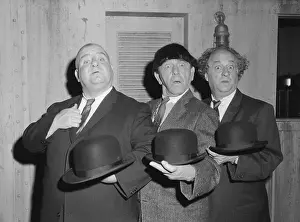 The Three Stooges Holding Bowler Hats