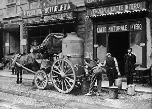 Store Workers Collecting Milk from Wagon
