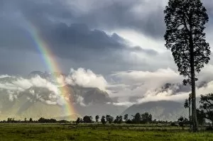 South Island Gallery: Storm clouds with rainbow, pasture against the Southern Alps, Fox, South Island, New Zealand