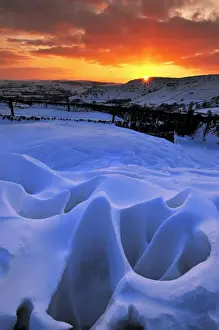 High Peak Prints: Strange natural snow formations at sunset with the Derbyshire countryside. UK