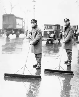 Raincoat Prints: Street Cleaners Pushing Squeegees
