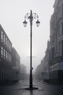 A street lamp and the Ferryquay Gate in the fog