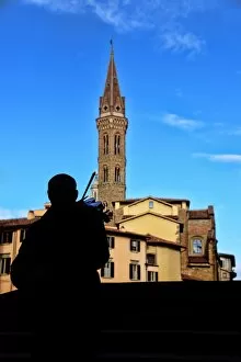 Images Dated 4th December 2016: Street musician plays a violin in front of Badia Fiorentina bell-tower in Florence, Italy