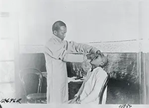 Caring Prints: Street Oculist with a Patient