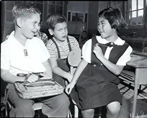 Displaying Prints: Student Shows Metal Tag To Classmates