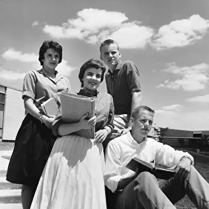 Four students on steps, posing